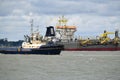 Tugs lead out a container ship from the port from Felixstowe UK Royalty Free Stock Photo