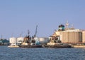 Tugs moored at an oil refinery on a sunny, Port of Antwerp, Belgium.