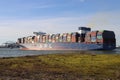 Tugship brings APL Merlion container ship inside the port of Rotterdam at the Maasvlakte Harbor Royalty Free Stock Photo