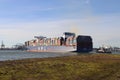 Tugship brings APL Merlion container ship inside the port of Rotterdam at the Maasvlakte Harbor Royalty Free Stock Photo