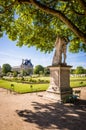 The Tuileries garden in Paris with the statue of Hercule Resting and the Louvre palace