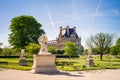 The Tuileries garden in Paris with the statue of the Good Samaritan and the Louvre palace