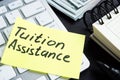 Tuition assistance handwritten on a piece of paper Royalty Free Stock Photo