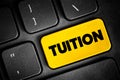 Tuition - fees charged by education institutions for instruction or other services, text button on keyboard, concept background Royalty Free Stock Photo
