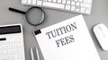 TUITION FEES text on paper with chart and keyboard, business concept Royalty Free Stock Photo