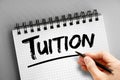 Tuition text on notepad, concept background Royalty Free Stock Photo