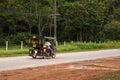 Tuk tuk taxi in Thailand countryside with two tourists on board. Ko Lanta