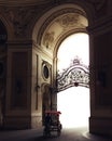 Tuk tuk driving through the huge building arch