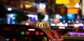 Tuk-Tuk Taxi sign with defocused lights blur in Chinatown in Bangkok at night Royalty Free Stock Photo