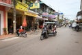 Tuk-tuk tourist taxi on the central street of the Siem Reap