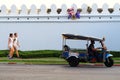 Tuk tuk and tourist walking near grand palace wall thailand tuk tuk is popular transportation Royalty Free Stock Photo