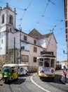 Tuk-tuk and yellow tram hot summer day lisbon Royalty Free Stock Photo