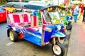 Tuk tuks lined up along a street in Bangkok Thailand