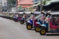 Tuk tuks lined up on a Bangkok street, Thailand