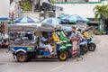 Tuk tuks waiting for business outside a ferry stop