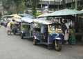 Tuk Tuks waiting for customers near Buddhist Temple