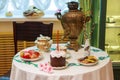 Tula city, Russia - May 2019: beautiful samovar, cookies, willow, easter cake with festive candle and colored eggs are on table.