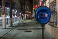 TULA, RUSSIA - APRIL 22, 2017: blue payphone post at night city sidewalk with selective focus Royalty Free Stock Photo