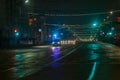 Tula, Russia - December 31, 2020: Ambulance car moving toward camera on empty night street in city