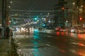 Tula, Russia - December 20, 2020: Night automobile traffic on wide city street - close-up telephoto shot