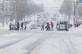 Tula, Russia - February 13, 2020: Citizens crossing city road during heavy snow fall.