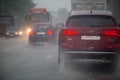 TULA, RUSSIA - JULY 14, 2020: Cars moving on asphalt road during heavy summer storm rain, view from back