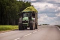 TULA, RUSSIA - JULY 30, 2019: tractor with green ensilage in the trailer rolling on summer road