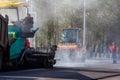 Tula, Russia - May 16, 2021: Process of asphalting, asphalt paver machine and road roller during road construction works