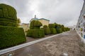 TULCAN, ECUADOR - JULY 3, 2016: cemeterys path with some graves on the right side and topiary figures on the left side