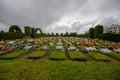 TULCAN, ECUADOR - JULY 3, 2016: lots of flowers adorn the tombs surrounded by plants sculptures