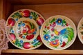 Tulchyn, Ukraine, traditional Ukrainian Petrykivka painting style, flower, bird and ornament paint on clay plate, ethno fair