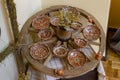 Tulchyn, Ukraine - 06.10.2020: traditional Ukrainian Podillia ornament painting style, clay plate on a wooden wagon wheel