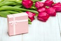 Tulip bouquet and small gift box on white wooden background, Royalty Free Stock Photo