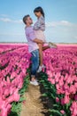 Tulip fields in the Netherlands, couple men and woman in flower field during Spring in the Nethertlands Royalty Free Stock Photo