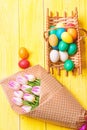 Tulip flower bouquet. Healthy and happy holiday. painted eggs in egg basket. Spring holiday. Holiday celebration