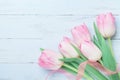 Tulip flowers decorated ribbon on blue table for Womans or Mothers day. Beautiful spring card. Top view. Royalty Free Stock Photo