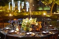 Night table set for dining and flowers decoration with candles indoor luxury wedding with low light romantic ambient