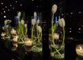 Tulip flowers decoration with candles at night, indoor luxury wedding with low light romantic ambient