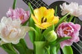 A bouquet of beautiful tulips on a lilac background and a fragment of a musical instrument ukulele.