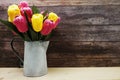 Tulip in Metal vase home decoration on wooden background Royalty Free Stock Photo