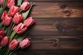 Tulips arranged as a topview frame on a wooden backdrop