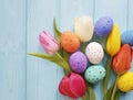 Bouquet tulips, easter eggs on blue wooden april Royalty Free Stock Photo