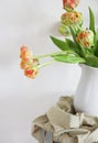 Tulips bouquet in white vase on wooden rustic chair Royalty Free Stock Photo