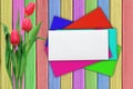 Tulips and colorful envelops over shabby paint wooden table Royalty Free Stock Photo