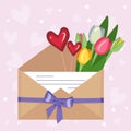 Tulips in a craft envelope with a love note and hearts Royalty Free Stock Photo