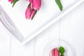 Tulips and dessert macaroon on a white background. Magenta color