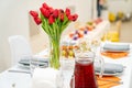 tulips on festive table. serving table with appetizers, canapes, salads in jars Royalty Free Stock Photo