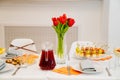 tulips on festive table. serving table with appetizers, canapes, salads in jars Royalty Free Stock Photo