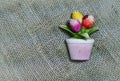 Tulips flower in vase as magnetic souvenir on sackcloth