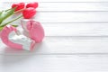 Tulips flowers and boxing gloves on wooden background, femenism concept